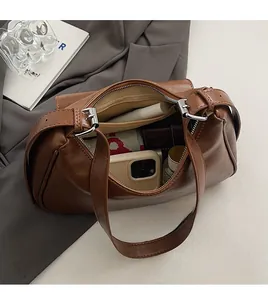 Interior view of the vintage brown shoulder bag showing spacious main compartment and zip pocket
