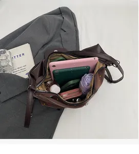 Spacious interior of dark brown tote bag showing large capacity for laptop and umbrella