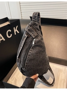 Modern washed denim crossbody sling bag with vintage texture and sleek silver zipper
