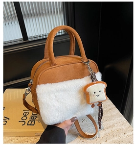 Detail of brown faux suede handbag with white plush trim and cute toast doll charm