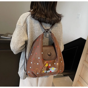 Brown polka dot backpack with a cute dog patch and adjustable dark straps