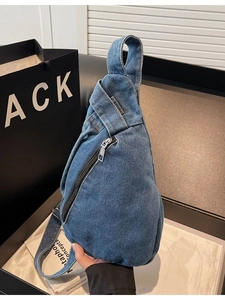 Light blue denim crossbody chest bag with vintage metallic zipper and top handle strap
