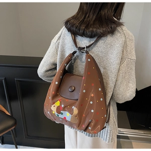 Close-up of brown crossbody bag featuring cute puppy embroidery and colorful dots