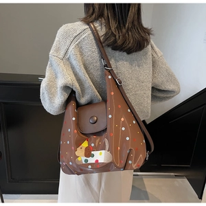 Close-up of brown tote bag with cartoon dog embroidery and colorful polka dots