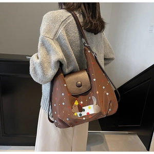 Close-up of brown tote bag featuring colorful polka dots and cute dog embroidery detail