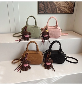 Detail of four colorful crossbody bags featuring embossed letters and cute bear pendants