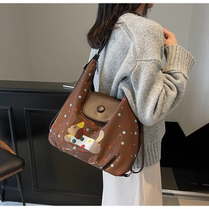 Detail of a brown tote bag with colorful polka dots and cute dog embroidery