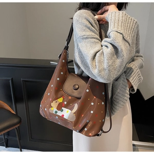 Brown tote bag detail with colorful polka dots and cute dog embroidery patch