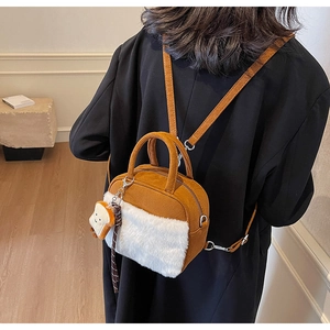 Close-up of caramel faux suede mini backpack with plush detail and cute bread charm