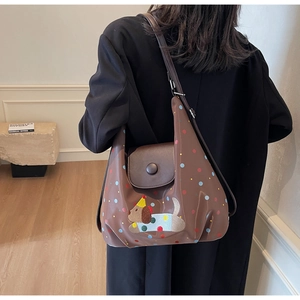 Brown crossbody bag featuring colorful polka dots and a cute cartoon dog patch detail