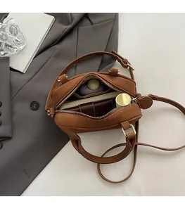 Top view of brown bowling bag interior showing capacity for wallet and cosmetics