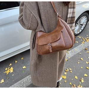 Retro brown underarm bag with oil-wax texture shown in an autumn street setting