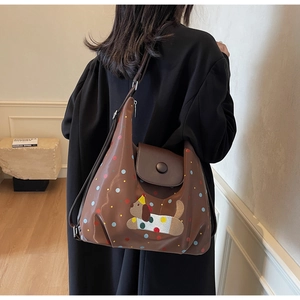 Detail of dark brown tote bag with colorful polka dots and embroidered dog patch design