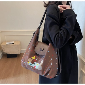 Detail of dark brown tote bag with colorful polka dots and cute cartoon dog print pattern
