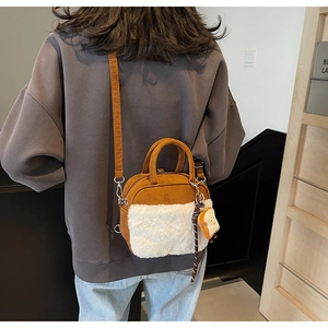 Detail of cute brown and white faux fur crossbody bag with a cartoon toast pendant