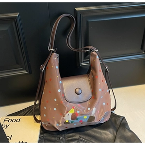Detail of brown tote bag with colorful polka dots and cute puppy cartoon embroidery