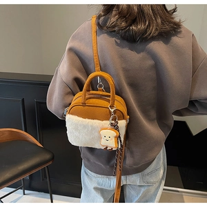Mini brown suede bag with faux shearling trim and cute plush toast charm pendant