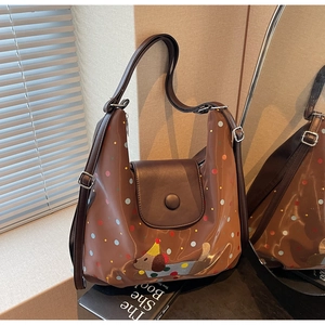 Detailed view of the brown retro shoulder bag featuring colorful dots and a cute puppy design