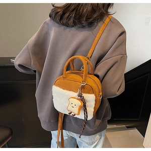 Detail of plush tote bag with furry trim and cute cartoon toast pendant accessory
