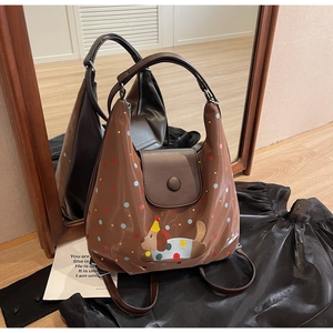 Close-up of brown polka dot crossbody bag with a cute cartoon dog embroidery detail