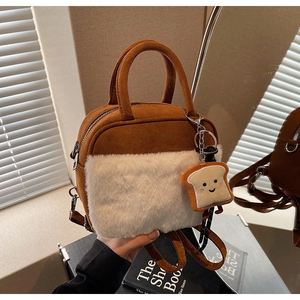 Close-up of brown suede mini bag with white faux fur and cute toast plush pendant detail
