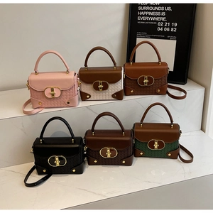 Close-up of small faux leather box bags in six colors with quilted texture and gold locks