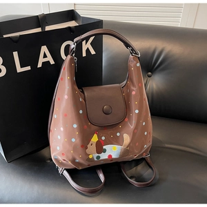 Detail of a brown multi-functional bag with colorful polka dots and cute dog embroidery
