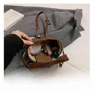 Interior view of brown leather bucket bag showing large capacity for cosmetics