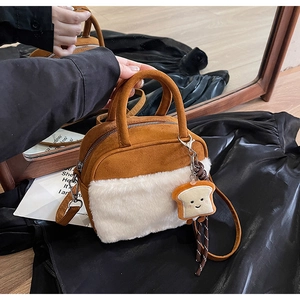 Detail of caramel suede and white plush mini bag featuring a cute toast charm
