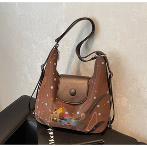 Detail of glossy brown tote with colorful polka dots and cute dog embroidery