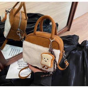 Detail of plush square bag with faux fur patchwork and cartoon toast charm