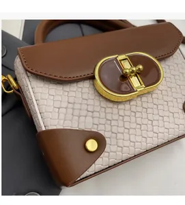 Detail of woven texture and vintage gold metal clasp on a stylish shoulder bag