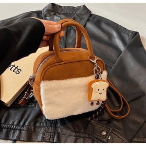 Close-up of brown suede mini square bag with white faux fur and toast plush charm
