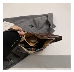 Interior view showing the large capacity and lining of the dark brown shoulder bag