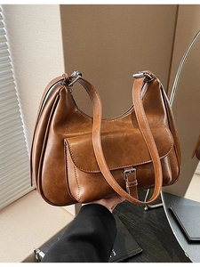 Brown vintage Hobo shoulder bag with metal buckle pocket detail in a handheld view
