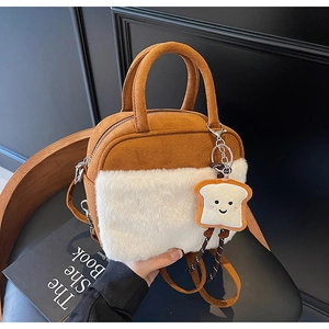 Brown suede mini bag with white plush trim and cute toast charm detail on a chair