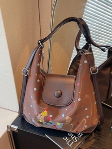 Brown tote bag with colorful polka dots and cute dog patch on a beige background