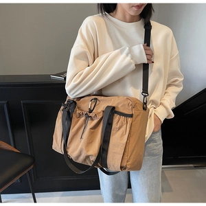 Outdoor style caramel nylon messenger bag with drawstring pocket and metal carabiner