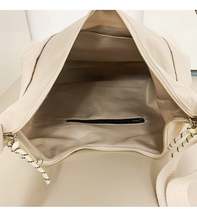 Detail of spacious tote bag interior with herringbone lining and rope zip puller