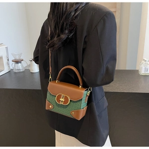 Retro contrast box bag in dark green woven texture with metallic clasp on a model