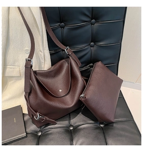 Detailed view of dark brown pebbled leather tote bag set with a matching small pouch