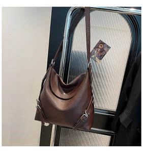 Detail of coffee brown litchi grain tote bag with silver buckle and magnetic closure