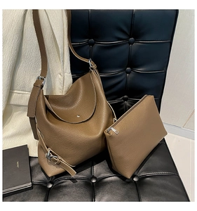 Detailed shot of earth-toned lychee texture bucket bag with matching zipper pouch