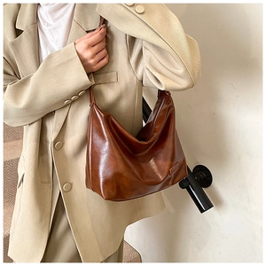Detail shot of the vintage dark brown PU leather hobo bag with a soft semi-circle design
