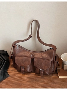 Vintage dark brown faux leather hobo bag with front pockets and wide shoulder strap