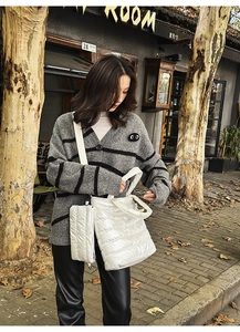 Detail of glossy quilted puffer tote bag with matching mini pouch and wide strap