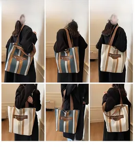 Detail view of large striped canvas tote bags with front pockets shown on model
