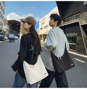 Detail of minimalist canvas crossbody bags in black and white for daily urban commuting