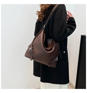 Detail of coffee brown tote bag showing lychee grain leather texture and buckle