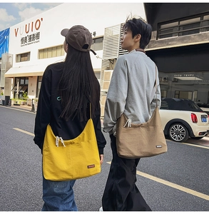 Detailed view of yellow and brown crescent-shaped nylon crossbody bags for daily commute